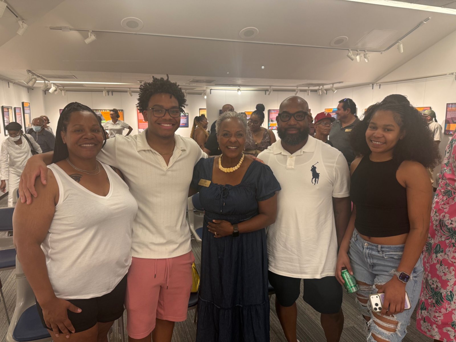 Stephanie Hancock stands with Aurora residents at a community event