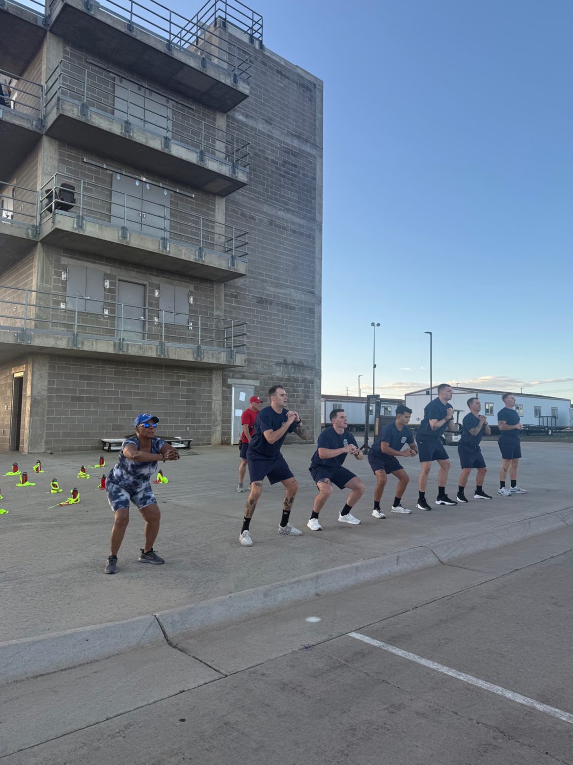 Stephanie Hancock joins Aurora Fire Rescue recruits during conditioning outside the training tower